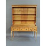 A reproduction pine dresser in George II style, the cornice above a boarded and shelved back the