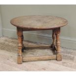 An oak drop leaf occasional table of oval outline on turned and square framing together with an