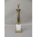A brass column lamp, the Corinthian capital above brass fluted tapered column, veined grey marble