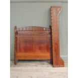 A Victorian Oregon pine bedstead the arched back applied with split mouldings, turned finials ,