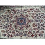 A Persian rug, the ivory ground having a pale blue central medallion within a surround of