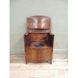 An early 19th century mahogany commode of bow front form, fitted faux drawer above pair of