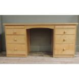 An oak veneered knee hole dressing table or desk, the rectangular top above an arched knee hole