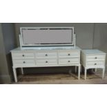 A modern cream painted dressing table and bedside chest, dressing table 145cm wide, bedside chest