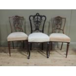 A pair of Victorian rosewood salon chairs with arched top rails, pierced vasular splats, carved with