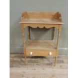 A pine wash stand with shaped three quarter gallery, turned supports, fitted with drawers to the