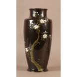 A Chinese vase of tapered form, the dark brown ground, moulded and painted with a prunus tree and