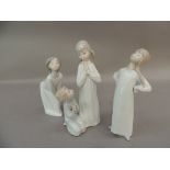 Three Lladro porcelain figures of children in night clothes, 22.5cm and smaller