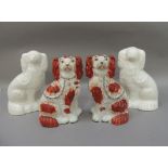 A pair of Victorian Staffordshire spaniels with rust red decorated bodies with gilt collars, black