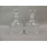 A pair of cut glass decanters and stoppers, 22cm high