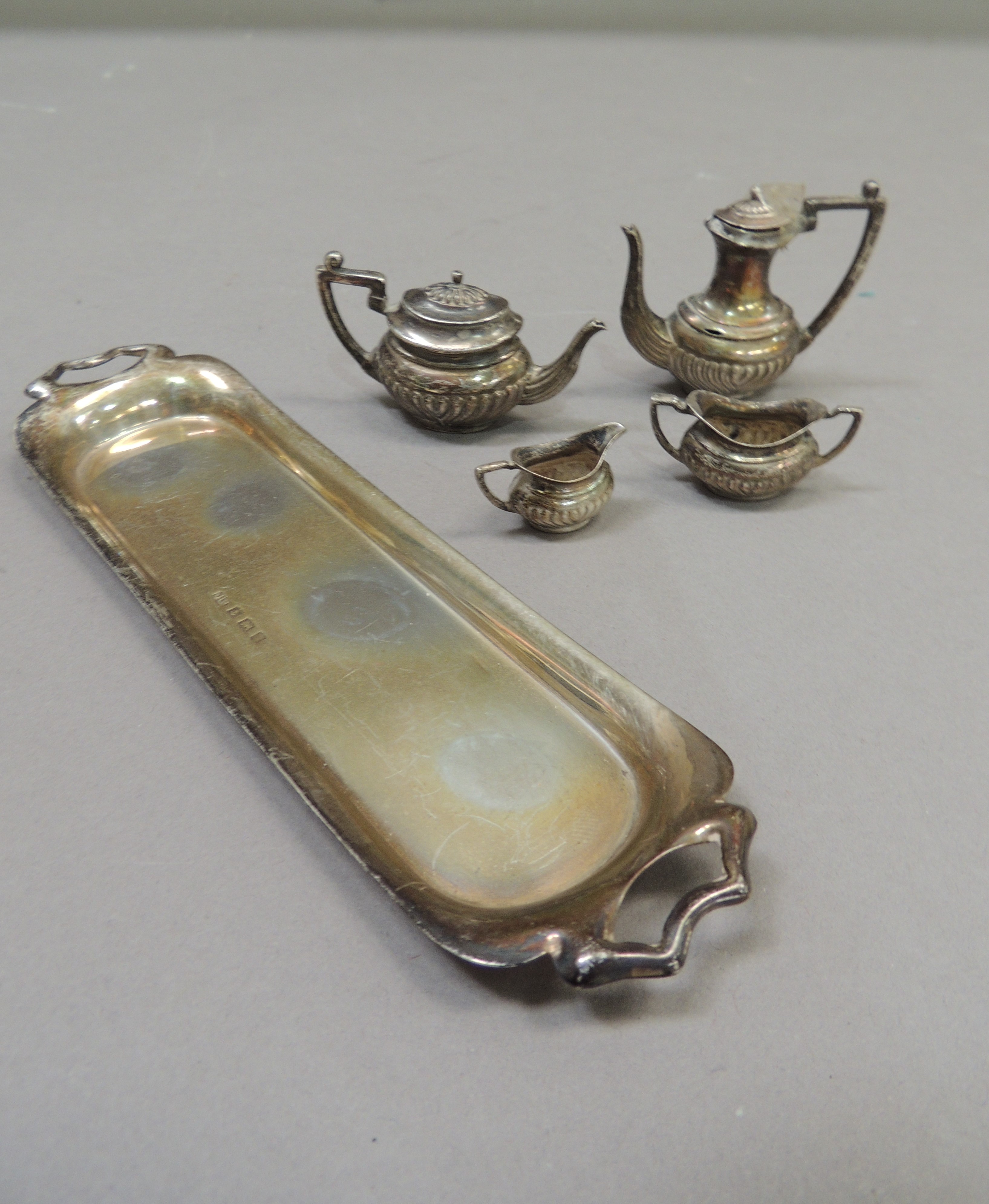 An Elizabeth II five piece miniature tea service in George V style comprising coffee pot, teapot,