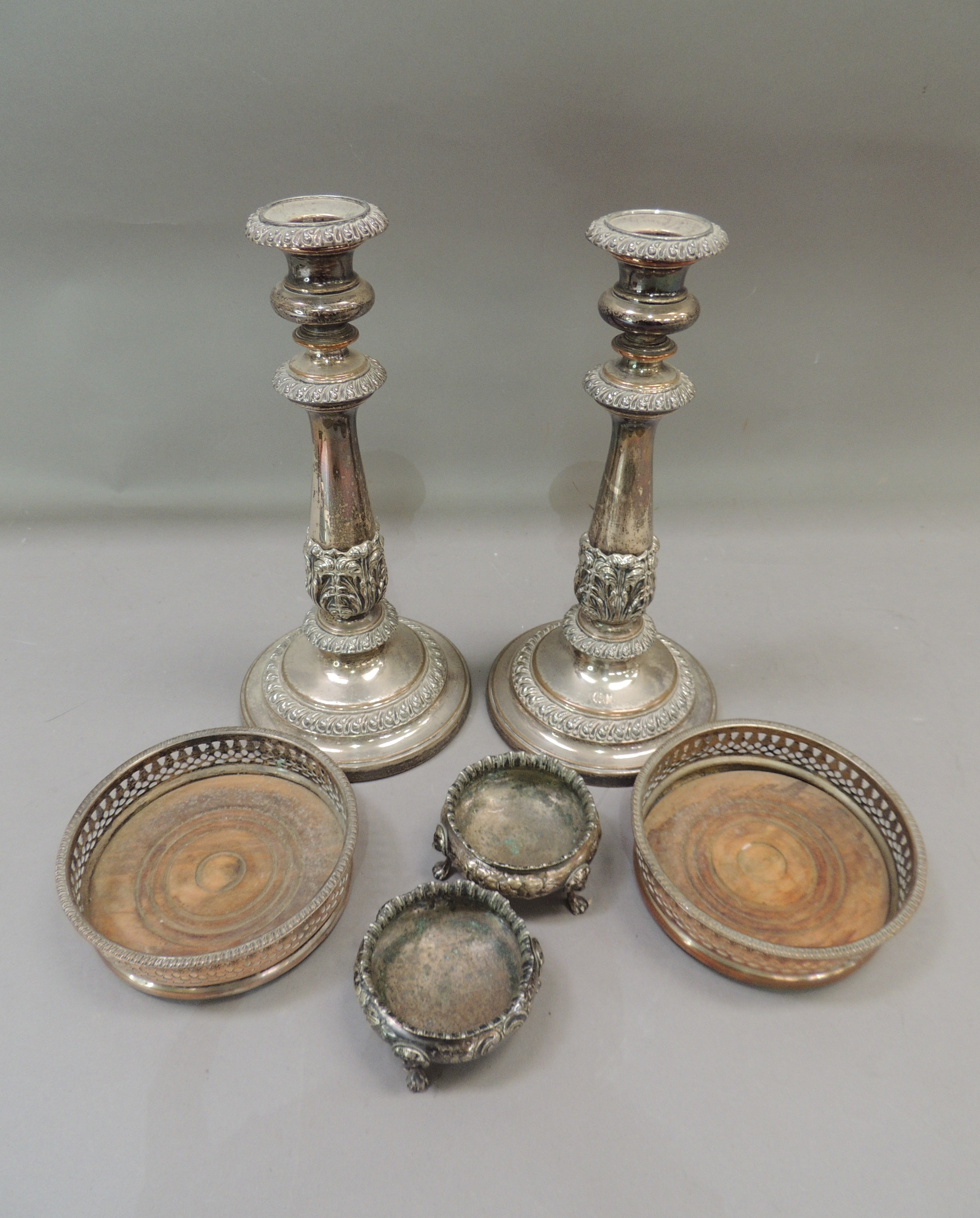A pair of Victorian silver plate on copper table candle sticks in Regency style, foliate wrapped
