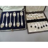 A cased set of silver tea spoons together with a set of silver coffee spoons with black coffee