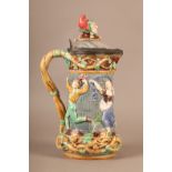 A Minton towered jug, with pewter mounted lid with jester finial, the body relief moulded with