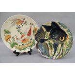 A continental terracotta pottery plate, slip decorated with a stylised fish, 4cm diameter;