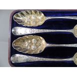 A set of four George II old English pattern spoons, later embossed with fruit and foliage, the