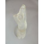 A Lalique figure of a reclining naked woman, circular base, engraved signature, 13cm high