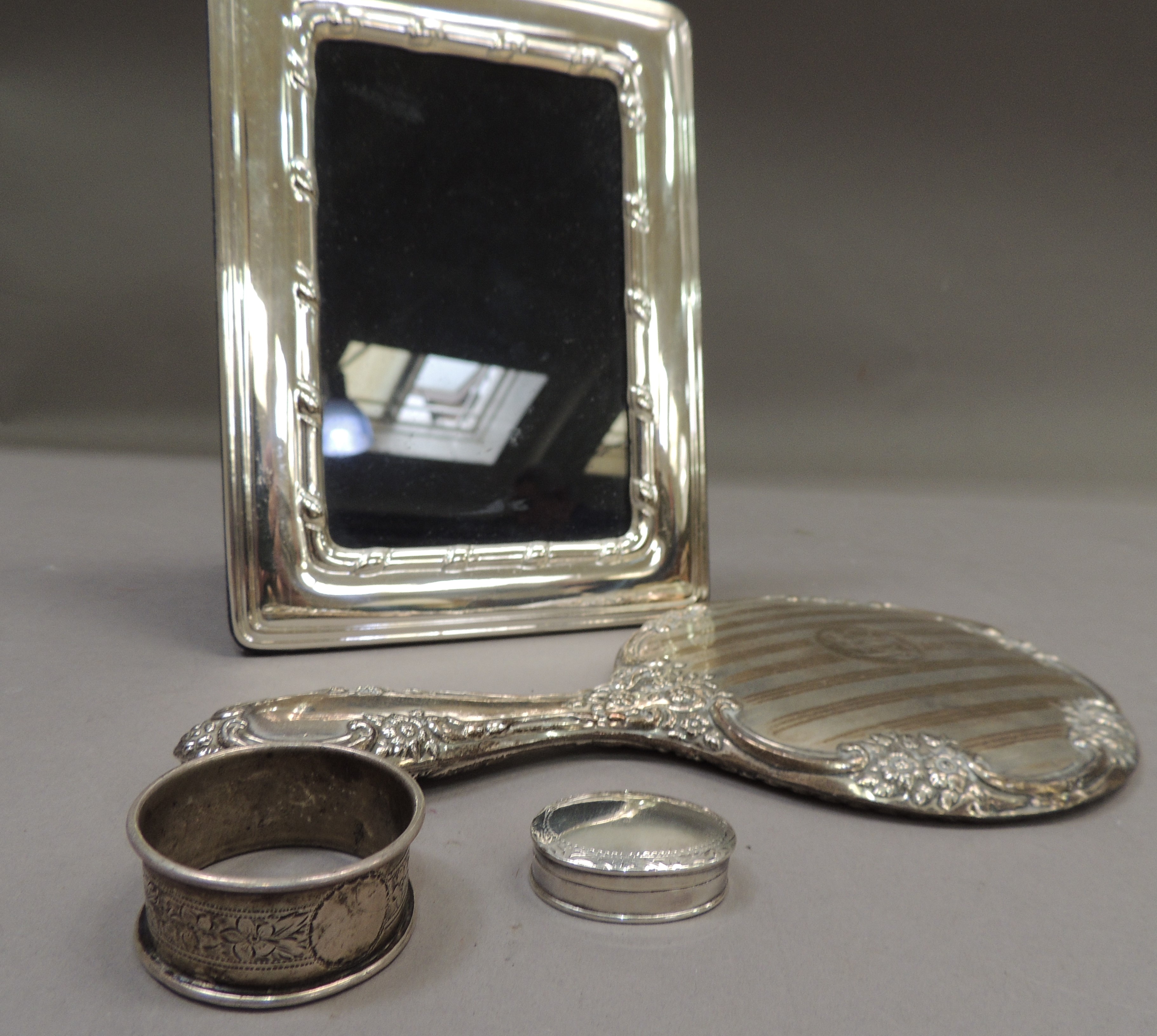 A silver photograph frame with reeded edge and ribbon slip, 20cm by 15cm; together with a silver