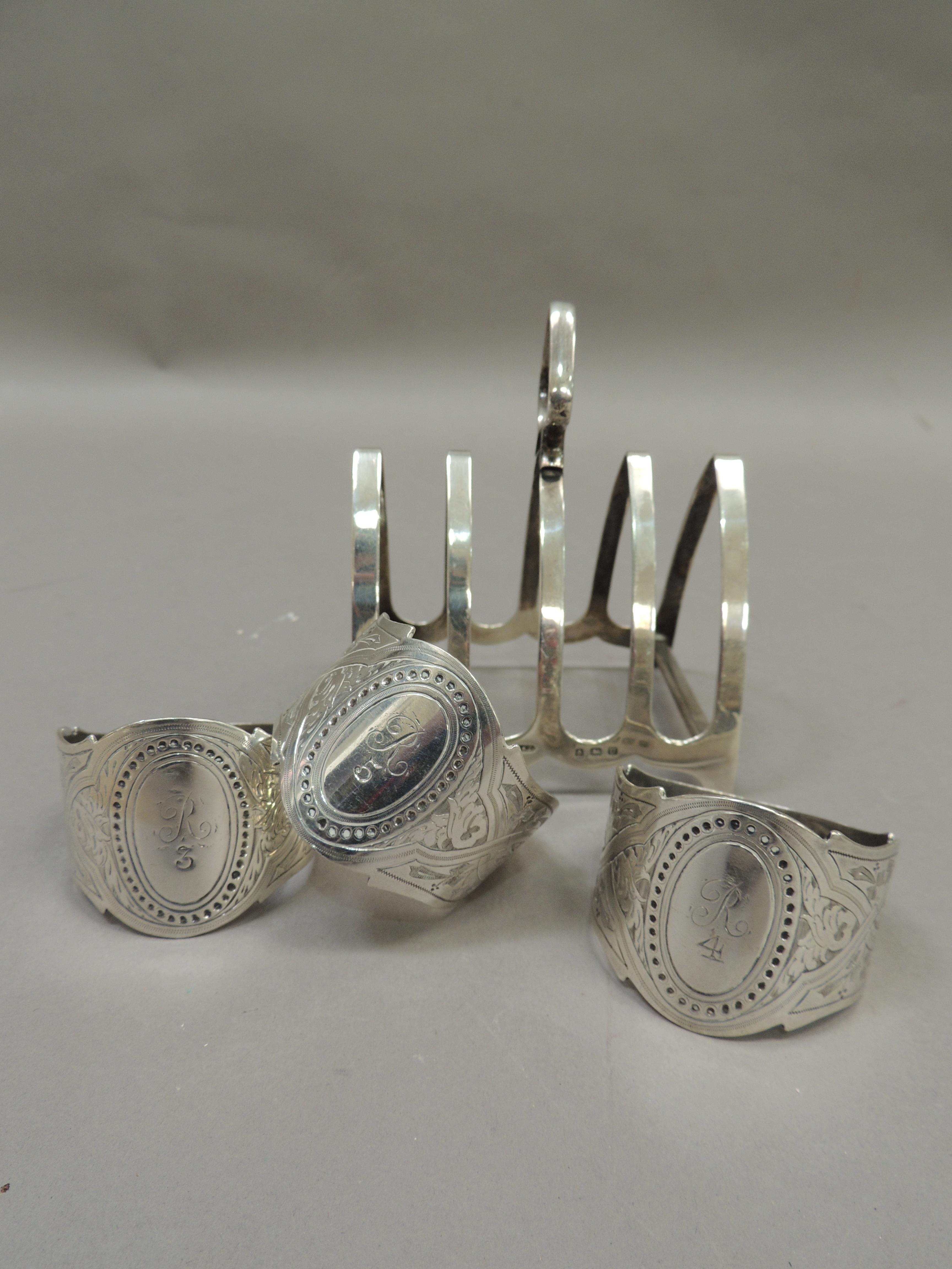A silver four division toast rack together with three silver napkin rings all initialled 'R', - Image 2 of 4