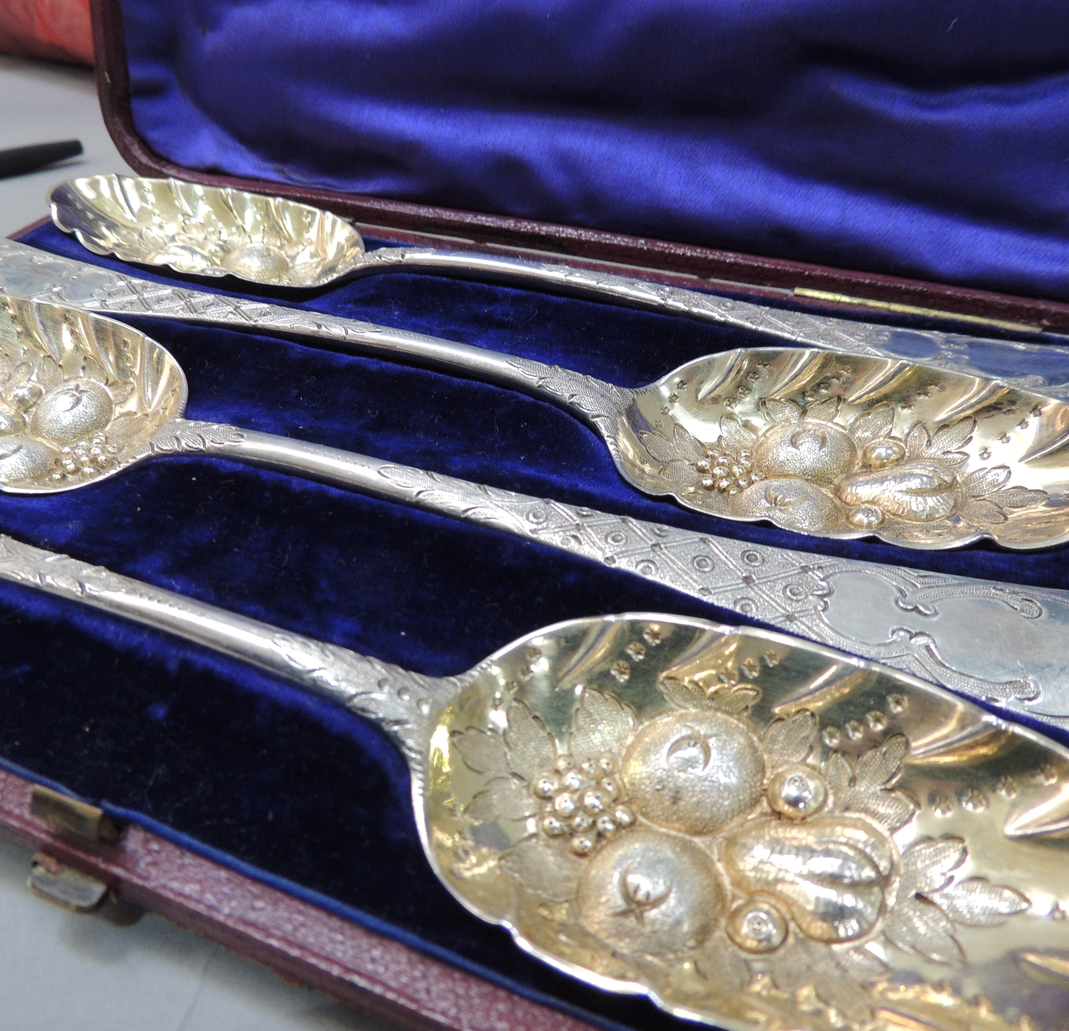 A set of four George II old English pattern spoons, later embossed with fruit and foliage, the - Image 3 of 3