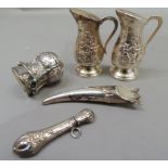 A quantity of silver and white metal items to include silver cased champagne cork, the top inscribed