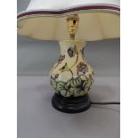 A Moorcroft table lamp, of floral design, 16cm high excluding fittings