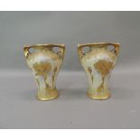 A pair of Amphora two handled vases gilt with poppies and other flowers, 14cm