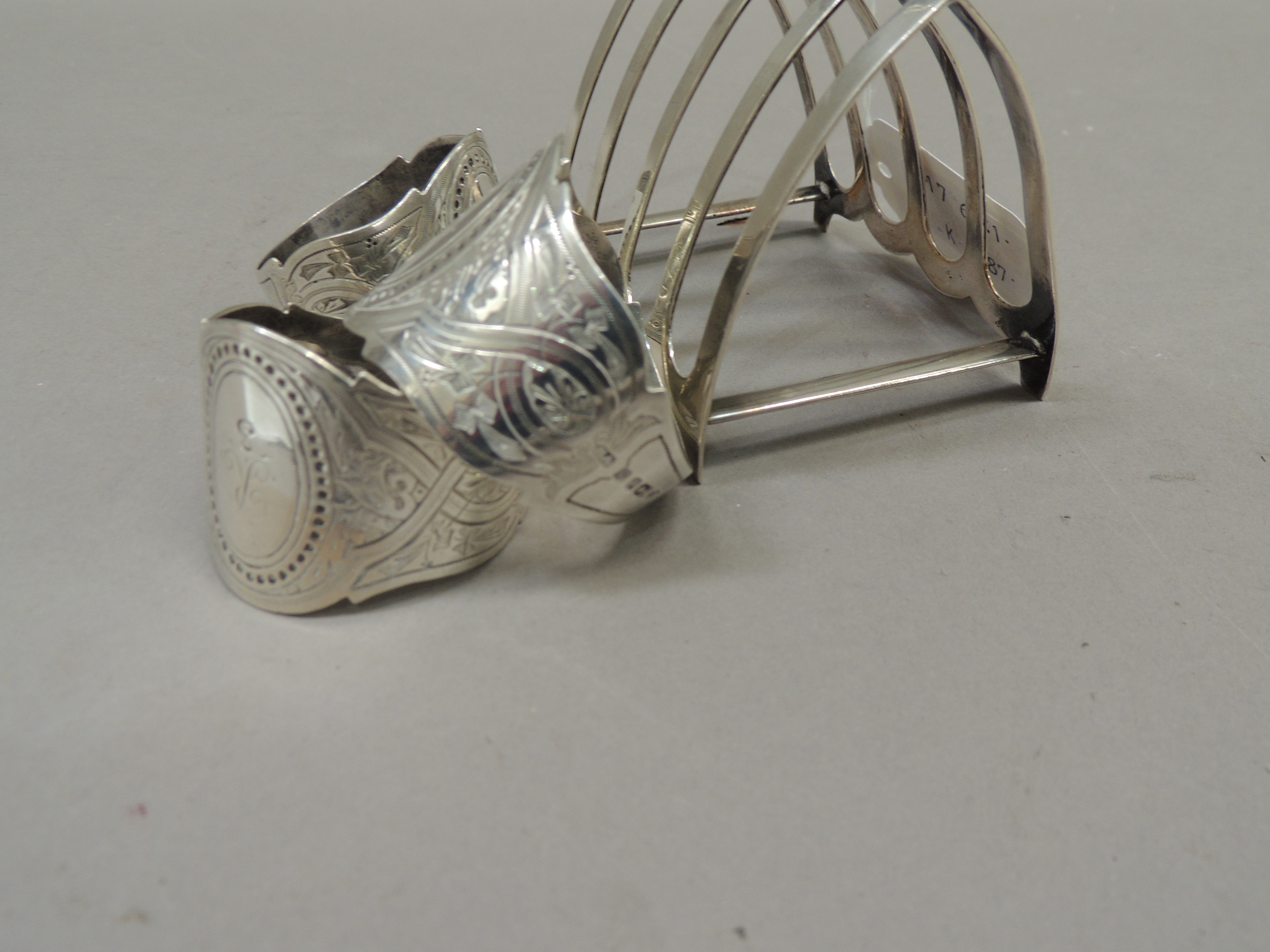 A silver four division toast rack together with three silver napkin rings all initialled 'R', - Image 3 of 4