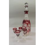 A Victorian ruby flashed decanter and four liqueurs, decanter 34cm high (5)