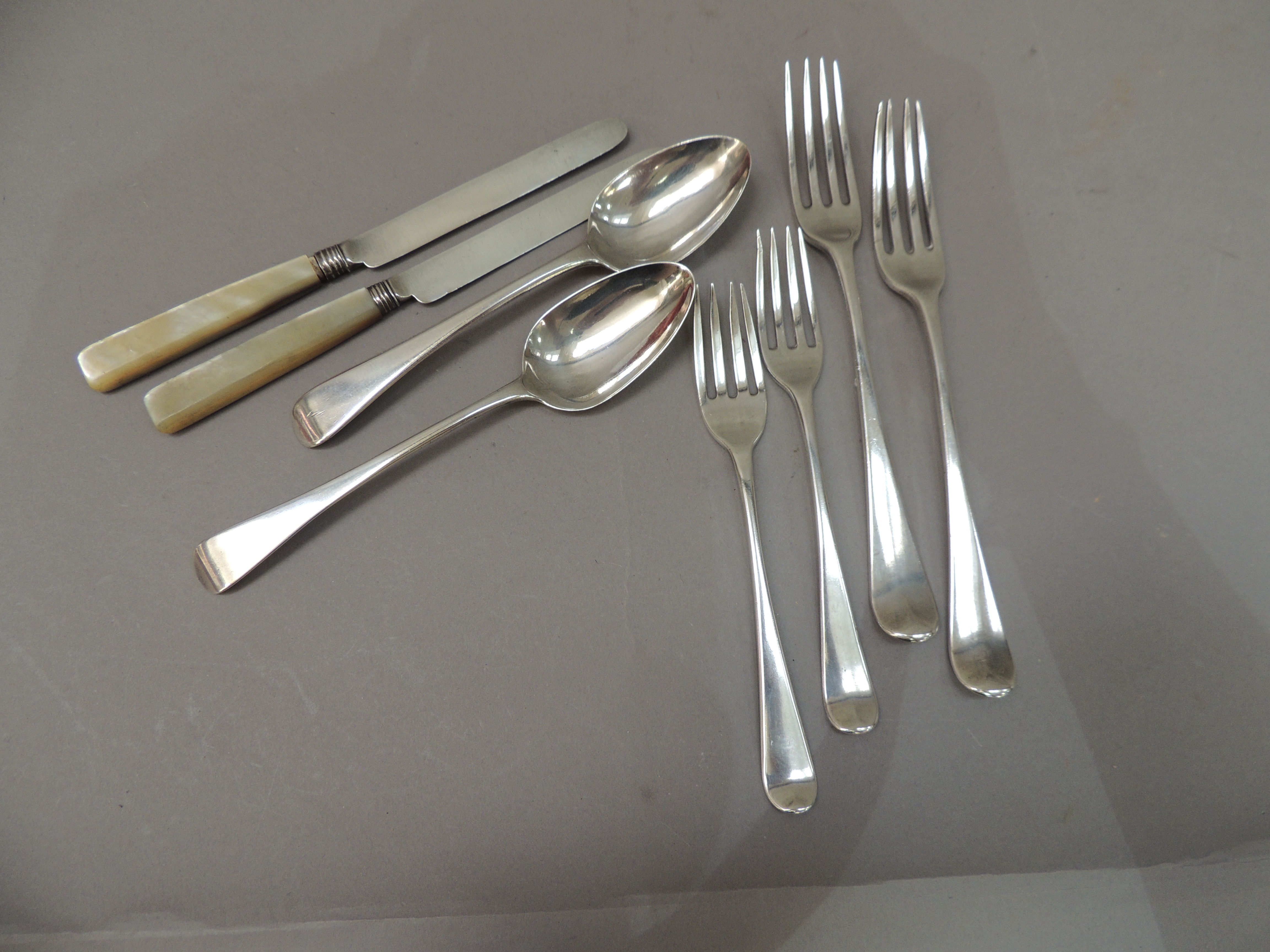 A quantity of George III, George IV table cutlery comprising two dessert spoons, two table forks,