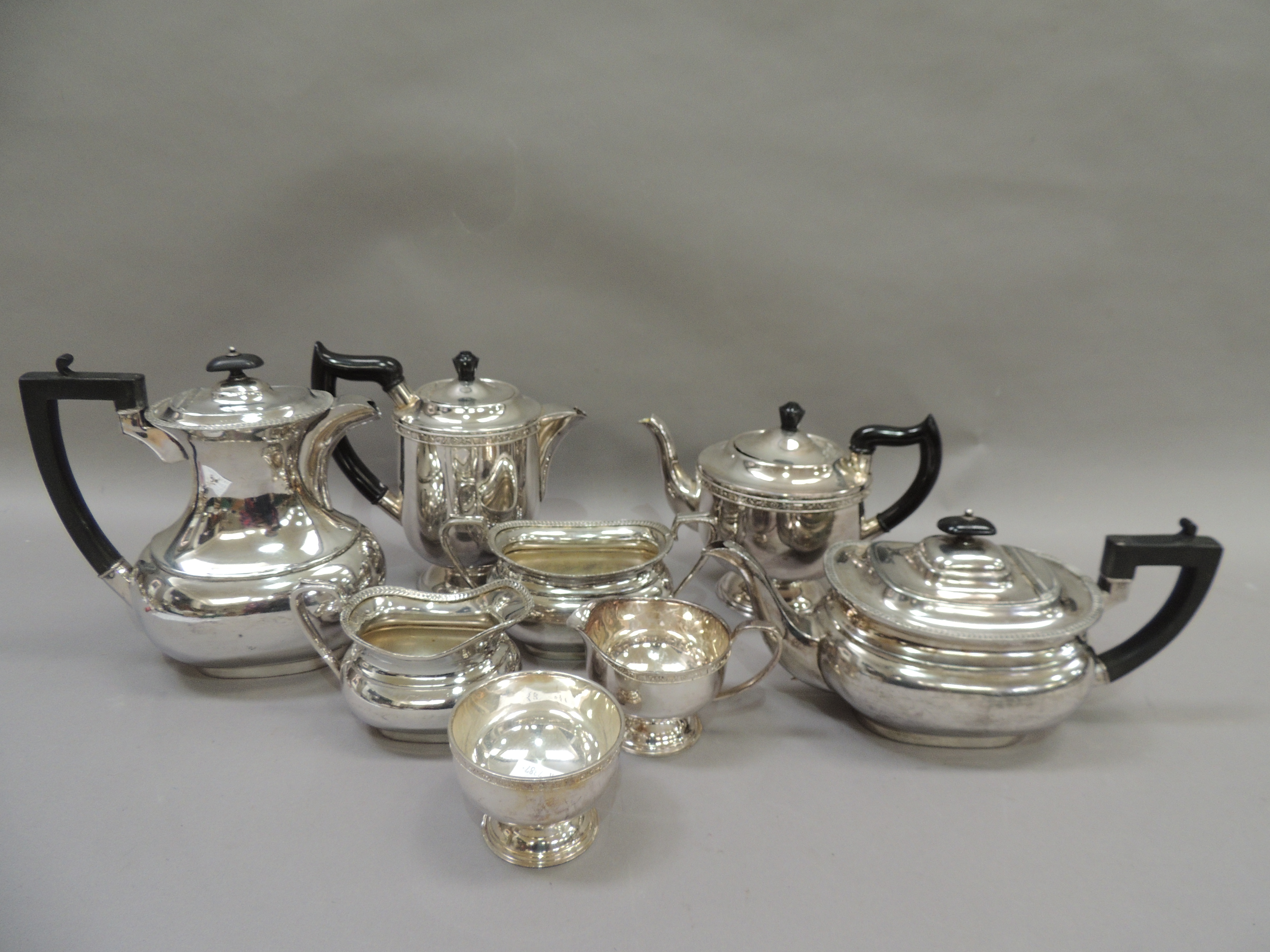 A quantity of silver plated items including two four piece tea services