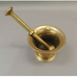 An antique bronze pestle and mortar, tapered cylindrical form with reeded bands, mortar 8.5cm