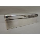 A rectangular silver cigarette box, slightly domed hinged lid, plain front, indistinct makers