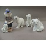 Three Lladro figures of polar bears together with a Ladro figure of an Inuit boy and polar bear,
