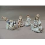 Four Lladro figures of young girls with puppies, kitten and dog, 14cm high and smaller