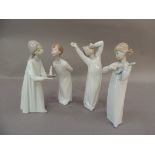 Four Lladro porcelain figures of young children in their night clothes, 21cm high and smaller