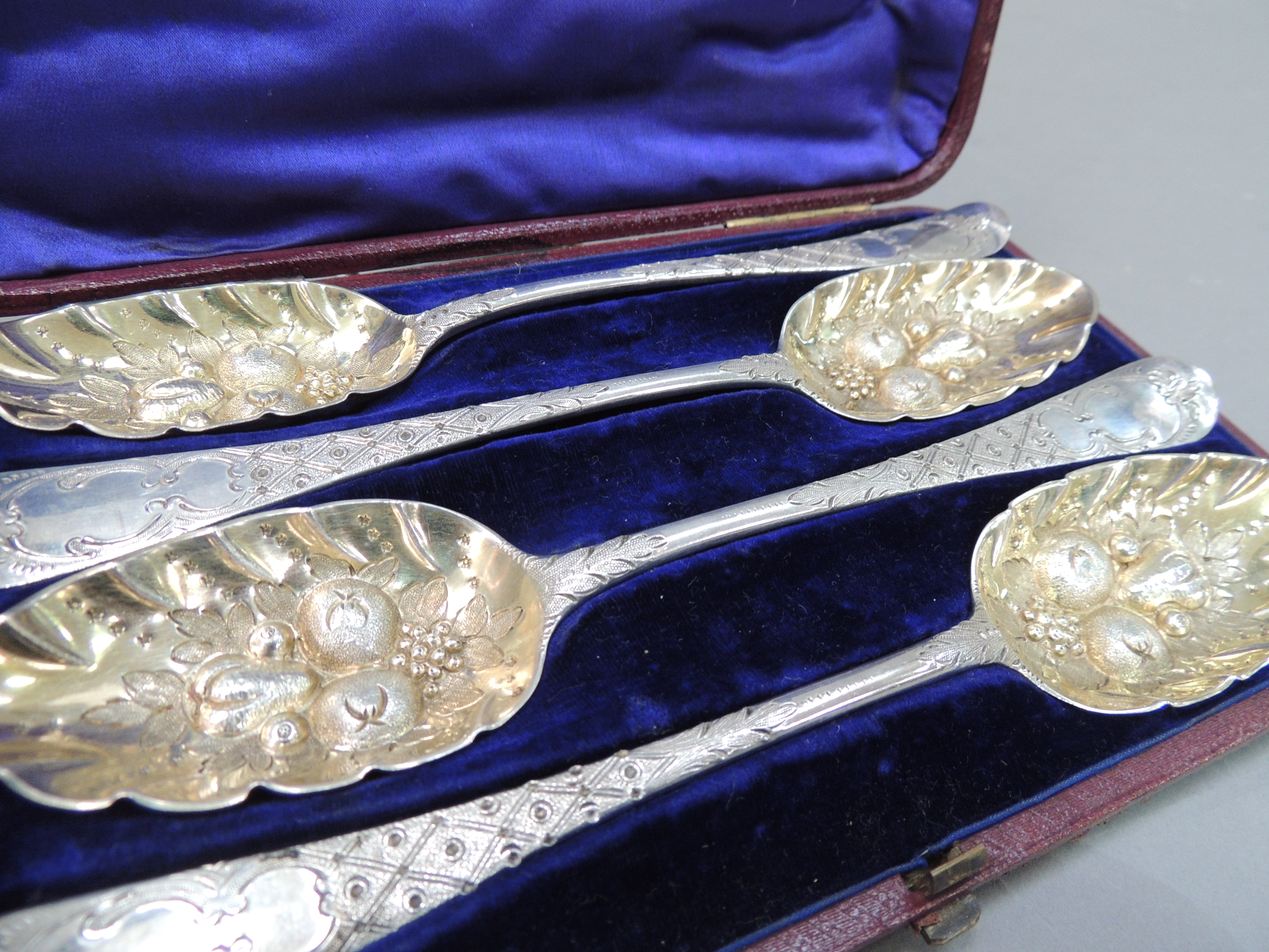 A set of four George II old English pattern spoons, later embossed with fruit and foliage, the - Image 2 of 3