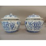 A pair of Chinese blue and white jars and covers decorated with geometric panels with stylised