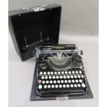 A vintage Continental black japanned typewriter in black fabric covered case
