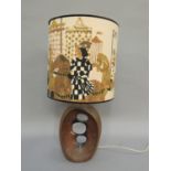 A pottery copper effect table lamp, ovoid with double-sided dished centre pierced with three