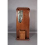 An oak veneered hall stand, c.1960s, with hat rail, mirror, coat hooks, integral cupboard with