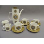 A J&G Meakin eleven piece coffee service decorated with an olive green and blue flower design on