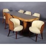 An Art Deco figured and crossbanded walnut dining table and chairs, the rectangular top with