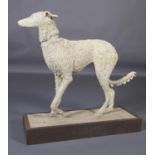 A ceramic figure of a lurcher, on naturalistic base and wood plinth, 87cm wide x 87cm high