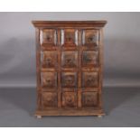 A Spanish chest of twelve small drawers, c.1970s, field panelled fronts with iron ring handles, twin