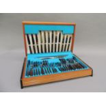 A 1960s mahogany and ebonised canteen of stainless steel and bahia wood cutlery by George Butler &