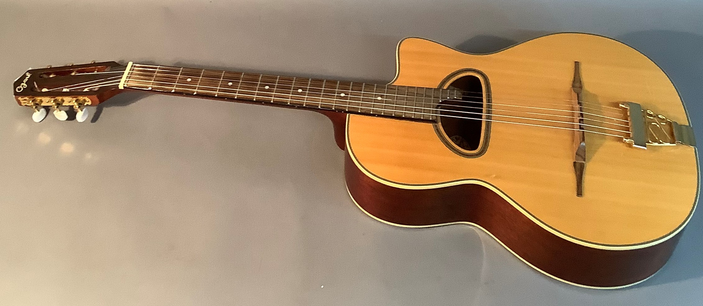 An Ozark gypsy guitar with 'D' sound hole, no.3513, with mahogany neck, rosewood fingerboard, gold