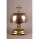 AN UNUSUAL AND LARGE BRONZE, cast iron and brass table bell with brass cruciform post and ball