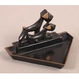 AN ART DECO BLACK JAPANNED BRASS PIN TRAY in the style of Hagenauer, the triangular shaped base