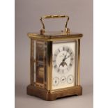 A MATTHEW NORMAN BRASS CASED FOUR DIAL CARRIAGE CLOCK with rolling moon phase, the dial with